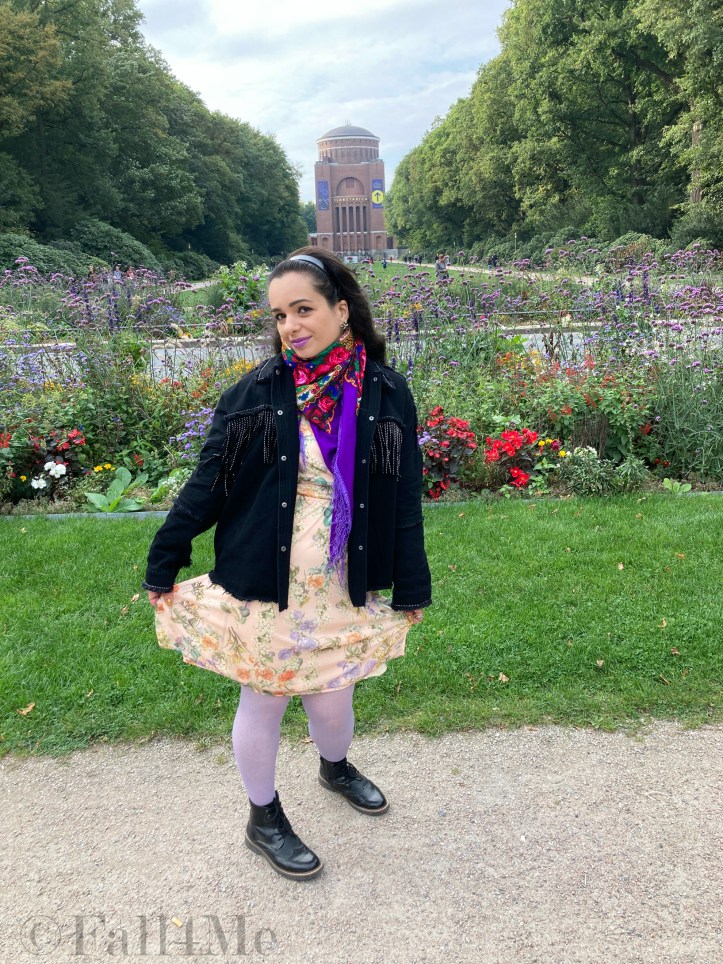 Combat boots worn with a summer dress, combined with a granny bag and fringes.