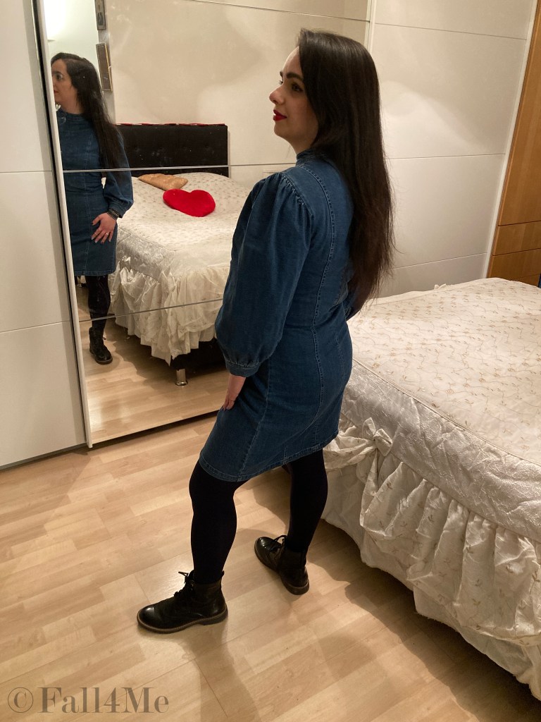 A denim dress with balloon sleeves combined with blue tights and combat boots.