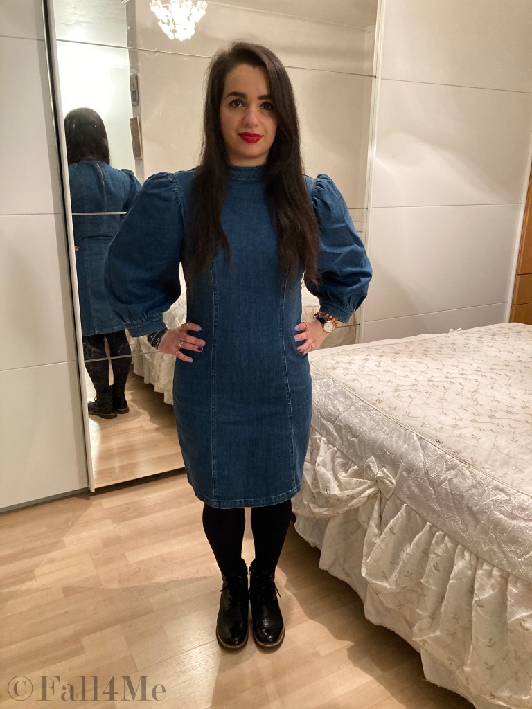 A denim dress with balloon sleeves combined with blue tights and combat boots.