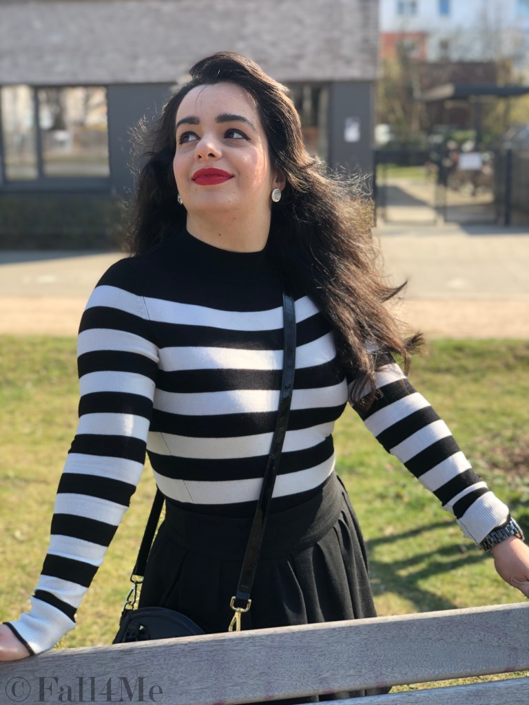 Black and white worn with a red accent.