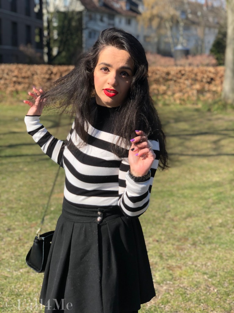 Black and white worn with a red accent.