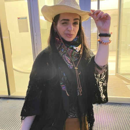 Fringes worn in the western style with a big floral colorful silk scarf.