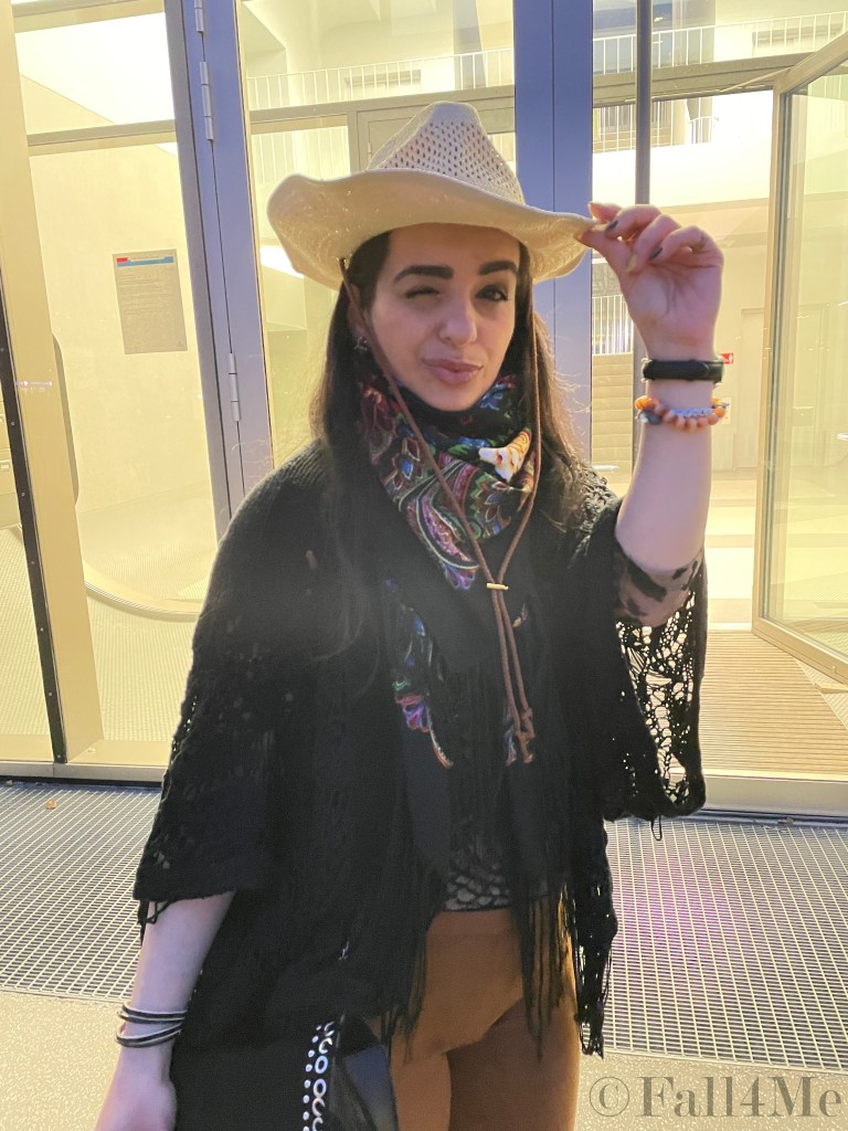 Fringes worn in the western style with a big floral colorful silk scarf.