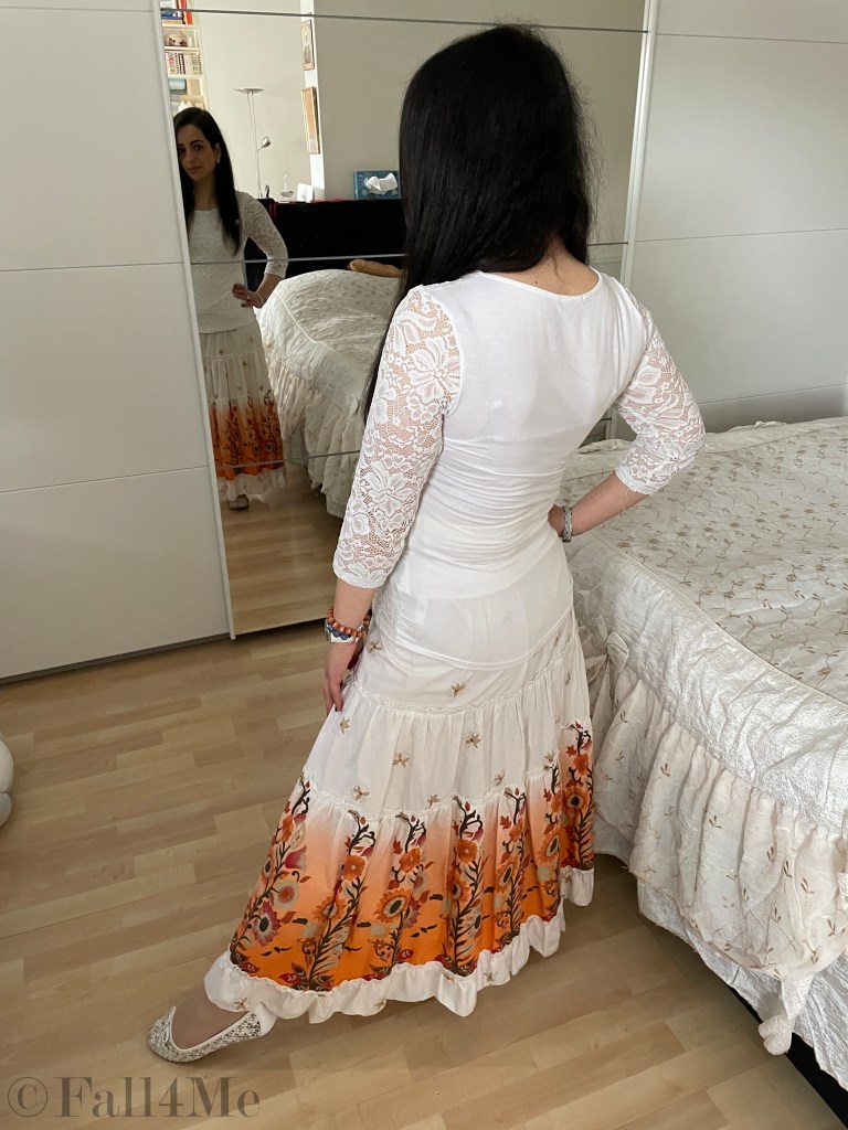 Smocked skirt combined with a white lace shirt.