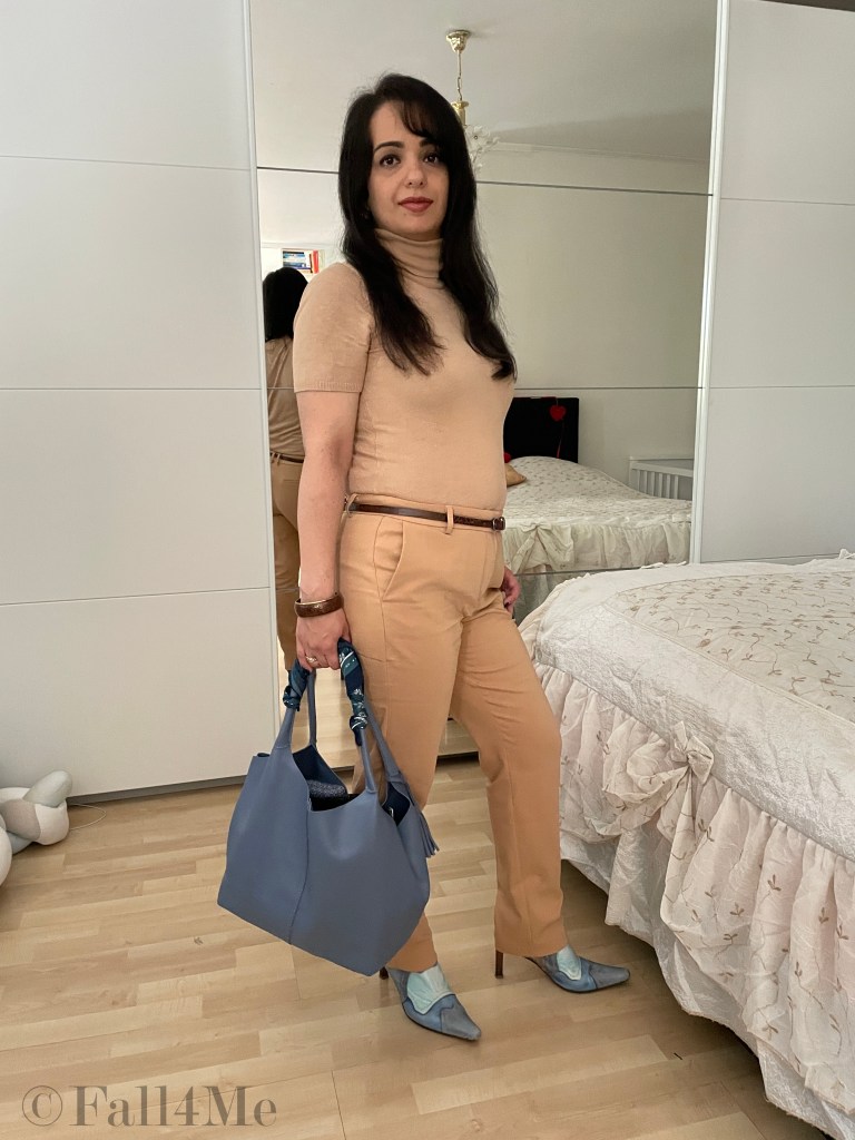 Masculine tailoring with business trousers and a turtle neck in beige and steel blue accessories.