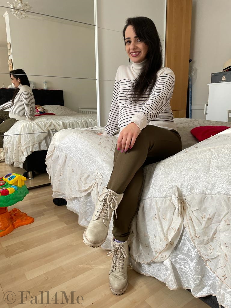 A choice of navy tops with a cream colored based, black stripes, olive green jogpants and cream colored combat boots.