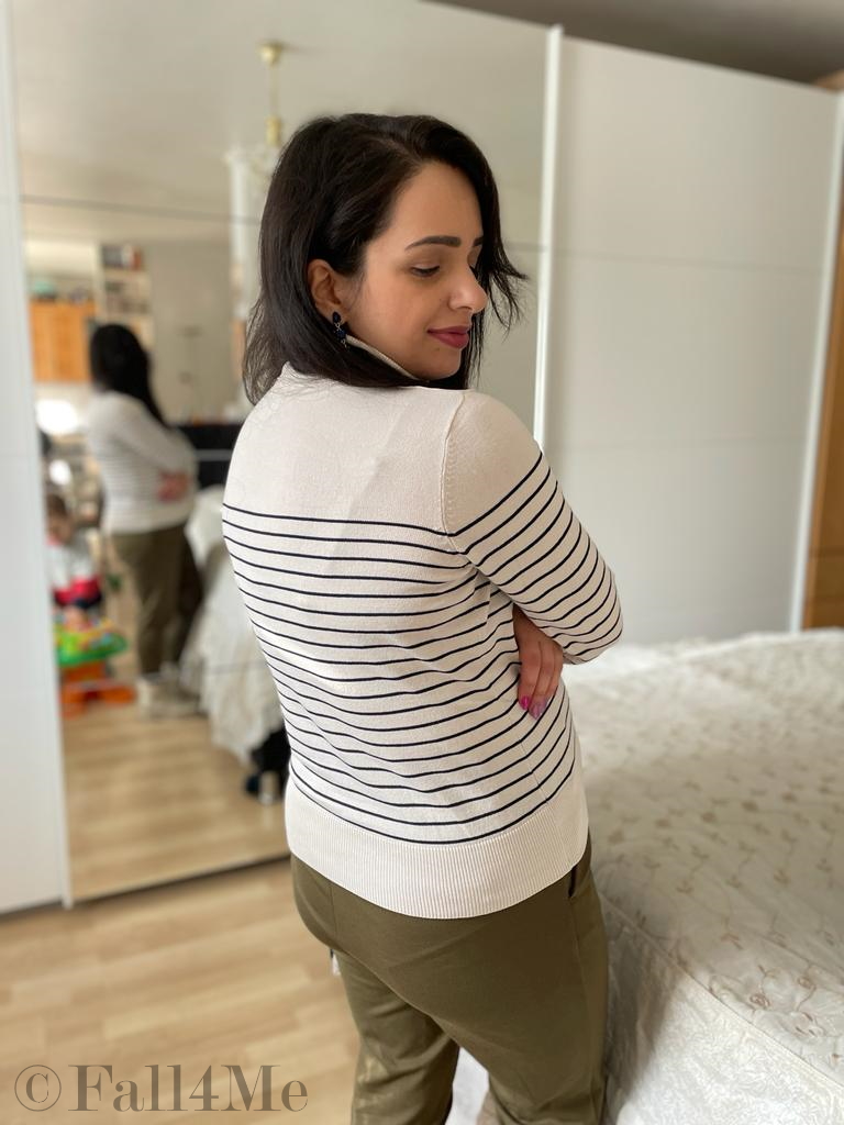 A choice of navy tops with a cream colored based, black stripes, olive green jogpants and cream colored combat boots.