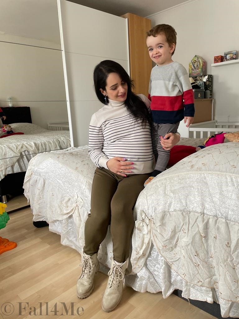 A choice of navy tops with a cream colored based, black stripes, olive green jogpants and cream colored combat boots.