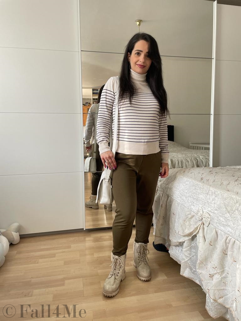 A choice of navy tops with a cream colored based, black stripes, olive green jogpants and cream colored combat boots.