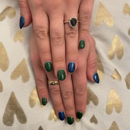 Glittery nails in blue and green.