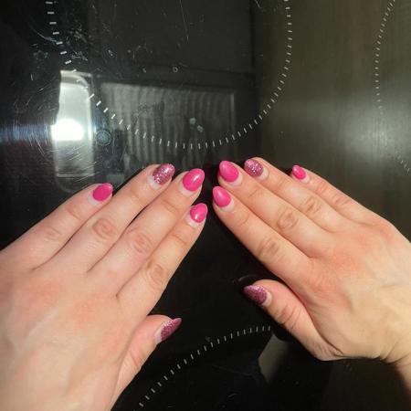 Nails in a gleaming and glittery tooling of pink.