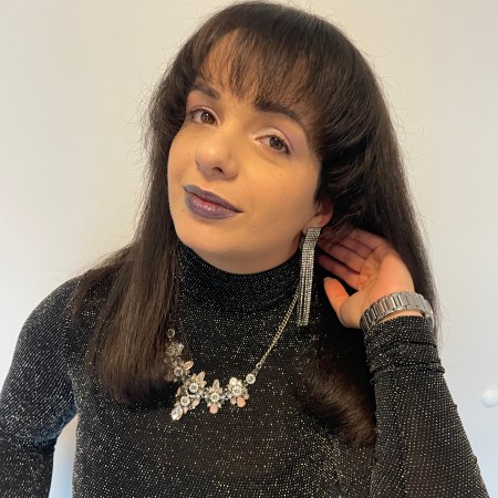 An outfit combining glitter and shiny elements from head to toe with dark berry lips and pastel eyes.