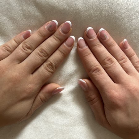French nails with three stones on each ring-finger.