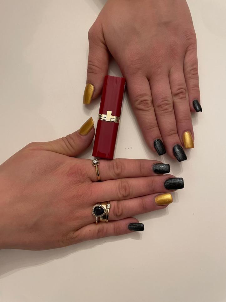 Nails in Black and Gold posing with red lipstick.