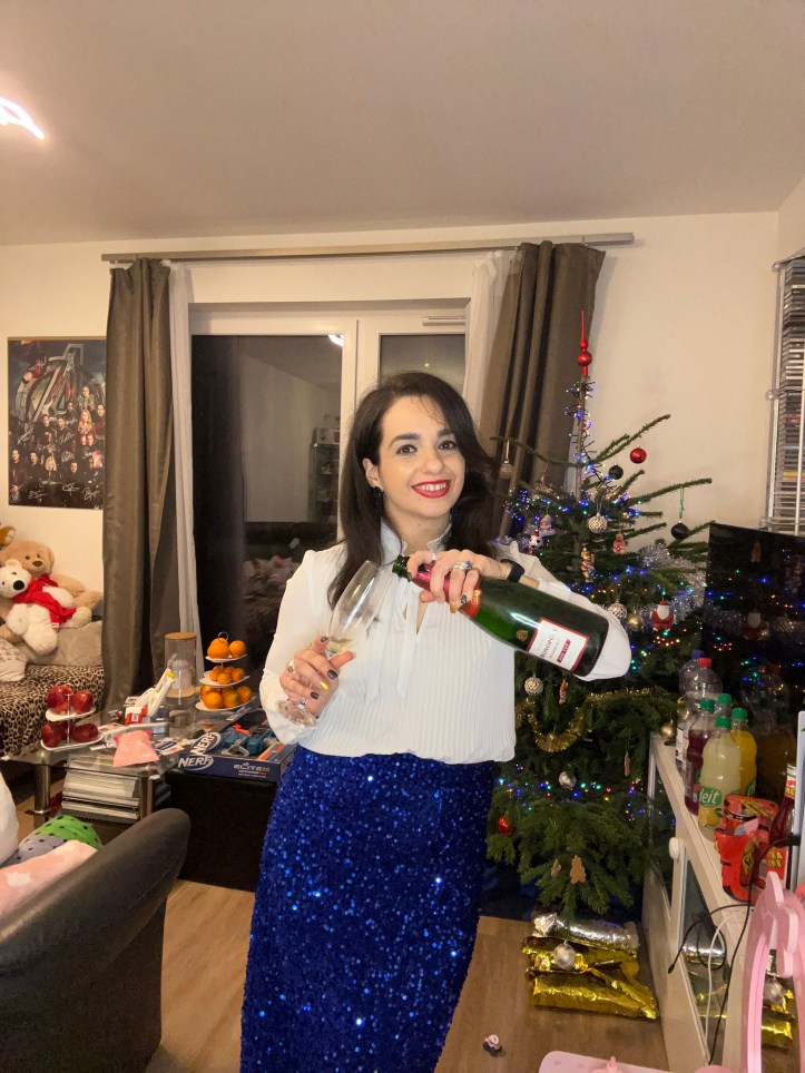 Filling a glass of champagne on New Year's Eve.